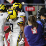 
              Michigan quarterback J.J. McCarthy (9) congratulates running back Donovan Edwards (7) after scoring a touchdown against Rutgers during the second half of an NCAA college football game, Saturday, Nov. 5, 2022 in Piscataway, N.J. (AP Photo/Noah K. Murray)
            