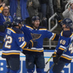 
              oSt. Louis Blues' Jordan Kyrou is congratulated by Justin Faulk (72) and Ivan Barbashev (49) after scoring during the second period of an NHL hockey game against the San Jose Sharks Thursday, Nov. 10, 2022, in St. Louis. (AP Photo/Jeff Roberson)
            