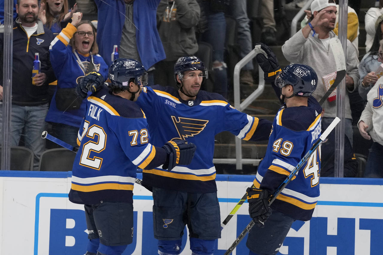 oSt. Louis Blues' Jordan Kyrou is congratulated by Justin Faulk (72) and Ivan Barbashev (49) after ...
