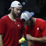 
              Jack Sock, left, speaks to Tommy Paul of the USA during their doubles match against Italy's Fabio Fognini and Simone Bolelli in a Davis Cup quarter-final tennis match between Italy and USA in Malaga, Spain, Thursday, Nov. 24, 2022. (AP Photo/Joan Monfort)
            