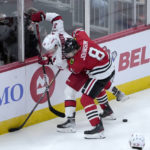 
              Carolina Hurricanes' Andrei Svechnikov (37) and Chicago Blackhawks' Jack Johnson (8) battle for the puck during the second period of an NHL hockey game Monday, Nov. 14, 2022, in Chicago. (AP Photo/Charles Rex Arbogast)
            