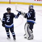 
              Winnipeg Jets' Dylan DeMelo (2) celebrates with goaltender Connor Hellebuyck (37) after defeating the Dallas Stars in an NHL hockey game, Tuesday, Nov. 8, 2022 in Winnipeg, Manitoba. (Fred Greenslade/The Canadian Press via AP)
            