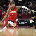 
              Houston Rockets guard Jalen Green (4) dribbles past Los Angeles Clippers guard Reggie Jackson, right, during the first half of an NBA basketball game, Monday, Nov. 14, 2022, in Houston. (AP Photo/Eric Christian Smith)
            