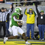 
              Oregon running back Bucky Irving (0) scores against Utah during the first half of an NCAA college football game Saturday, Nov. 19, 2022, in Eugene, Ore. (AP Photo/Andy Nelson)
            