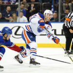 
              New York Rangers defenseman Adam Fox (23) and Edmonton Oilers center Connor McDavid (97) fight for the puck during the first period of an NHL hockey game, Saturday, Nov. 26, 2022, in New York. (AP Photo/Julia Nikhinson)
            