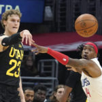 
              Utah Jazz forward Lauri Markkanen, left passes as Los Angeles Clippers guard Terance Mann defends during the second half of an NBA basketball game Sunday, Nov. 6, 2022, in Los Angeles. (AP Photo/Mark J. Terrill)
            