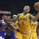 
              Baylor guard Keyonte George (1) pulls in a loose rebound over McNeese State forward Christian Shumate (24) in the second half of an NCAA college basketball game, Wednesday, Nov. 23, 2022, in Waco, Texas. (AP Photo/Rod Aydelotte)
            