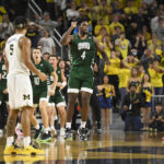 
              Ohio forward Dwight Wilson III (4) reacts after scoring as time expired in the second half of an NCAA college basketball game to send it into overtime against Michigan, Sunday, Nov. 20, 2022, in Ann Arbor, Mich. (AP Photo/Jose Juarez)
            