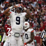 
              Auburn quarterback Robby Ashford (9) celebrates after scoring a touchdown against Alabama during the first half of an NCAA college football game Saturday, Nov. 26, 2022, in Tuscaloosa, Ala. (AP Photo/Butch Dill)
            