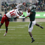 
              Michigan State receiver Jayden Reed, right, catches a pass against Rutgers defensive back Max Melton (16) during the first half of an NCAA college football game, Saturday, Nov. 12, 2022, in East Lansing, Mich. (AP Photo/Al Goldis)
            