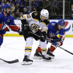 
              Boston Bruins left wing Tomas Nosek (92) works for the puck between New York Rangers' Chris Kreider (20) and Jacob Trouba during the first period of an NHL hockey game Thursday, Nov. 3, 2022, in New York. (AP Photo/Adam Hunger)
            
