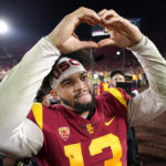
              Southern California quarterback Caleb Williams gestures to fans after USC defeated Notre Dame 38-27 an NCAA college football game Saturday, Nov. 26, 2022, in Los Angeles. (AP Photo/Mark J. Terrill)
            