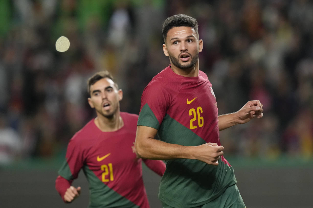 Portugal's Goncalo Ramos, right, celebrates after scoring his side's third goal during an internati...