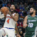
              New York Knicks guard Derrick Rose (4) attempts a layup as Detroit Pistons guard Cory Joseph (18) defends during the second half of an NBA basketball game, Tuesday, Nov. 29, 2022, in Detroit. (AP Photo/Carlos Osorio)
            