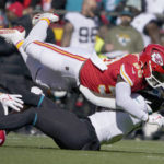 
              Jacksonville Jaguars running back Travis Etienne Jr., bottom, is stopped by Kansas City Chiefs linebacker Willie Gay (50) during the first half of an NFL football game Sunday, Nov. 13, 2022, in Kansas City, Mo. (AP Photo/Ed Zurga)
            