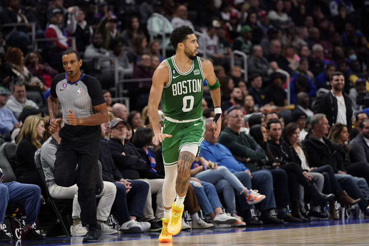 Boston Celtics forward Jayson Tatum runs up court after a three-point basket during the second half...