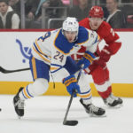 
              Buffalo Sabres center Dylan Cozens (24) passes as Detroit Red Wings left wing Lucas Raymond (23) defends in the second period of an NHL hockey game Wednesday, Nov. 30, 2022, in Detroit. (AP Photo/Paul Sancya)
            