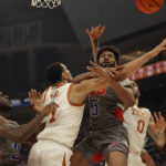 
              Houston Christian forward Jason Thompson (5) is blocked by Texas forward Dylan Disu (1) as he tries to score during the first half of an NCAA college basketball game, Thursday, Nov. 10, 2022, in Austin, Texas. (AP Photo/Eric Gay)
            