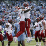 
              North Carolina State quarterback Jack Chambers (14) celebrates his touchdown with quarterback Ben Finley (10) during the first half of an NCAA college football game against North Carolina Friday, Nov. 25, 2022, in Chapel Hill, N.C. (AP Photo/Chris Seward)
            