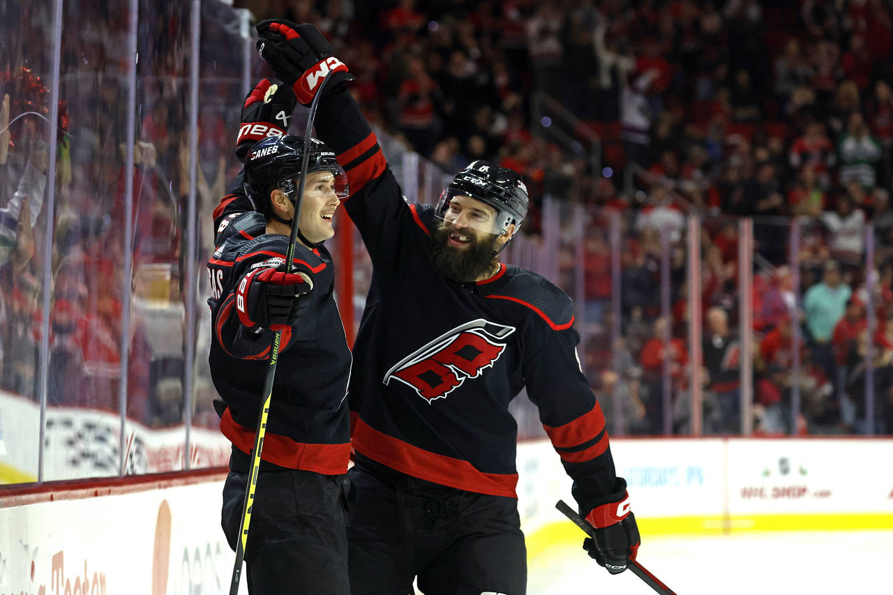 Carolina Hurricanes' Martin Necas (88) celebrates his goal with teammate Brent Burns (8) during the...