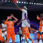 
              In a photo provided by Bahamas Visual Services, Kansas' Dajuan Harris Jr. shoots next to Tennessee's Uros Plavsic during an NCAA college basketball game in the Battle 4 Atlantis at Paradise Island, Bahamas, Friday, Nov. 25, 2022. (Tim Aylen/Bahamas Visual Services via AP)
            