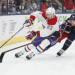 
              Montreal Canadiens' Evgenii Dadonov, left, carries the puck behind the net as Columbus Blue Jackets' Jake Christiansen defends during the first period of an NHL hockey game Thursday, Nov. 17, 2022, in Columbus, Ohio. (AP Photo/Jay LaPrete)
            