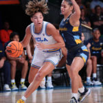 
              In a photo provided by Bahamas Visual Services, UCLA's Kiki Rice, left, controls the ball against Marquette's Nia Clarke, right, during the NCAA college basketball championship game in the Battle 4 Atlantis at Paradise Island, Bahamas, Monday, Nov. 21, 2022. (Tim Aylen/Bahamas Visual Services via AP)
            