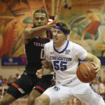 
              Creighton guard Baylor Scheierman (55) is guarded by Texas Tech forward Kevin Obanor (0) during the first half of an NCAA college basketball game, Monday, Nov. 21, 2022, in Lahaina, HI. (AP Photo/Marco Garcia)
            