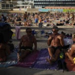 
              Beachgoers enjoy the sun and high temperatures in Marseille, southern France, Saturday, Oct. 29, 2022. (AP Photo/Daniel Cole)
            