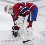 
              Montreal Canadiens goaltender Jake Allen picks up his broken stick after smashing it during the third period of an NHL hockey game in Montreal, Tuesday, Nov. 22, 2022. (Graham Hughes/The Canadian Press via AP)
            