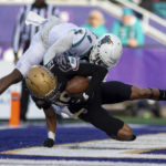 
              James Madison wide receiver Devin Ravenel (19) gets tackled in the end zone by Coastal Carolina safety Tobias Fletcher (4) for a touchdown during the second half of an NCAA college football game in Harrisonburg, Va., Saturday, Nov. 26, 2022. (Daniel Lin/Daily News-Record via AP)
            