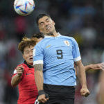 
              Uruguay's Luis Suarez, right, and South Korea's Kim Jin-su go for a header during the World Cup group H soccer match between Uruguay and South Korea, at the Education City Stadium in Al Rayyan , Qatar, Thursday, Nov. 24, 2022. (AP Photo/Martin Meissner)
            