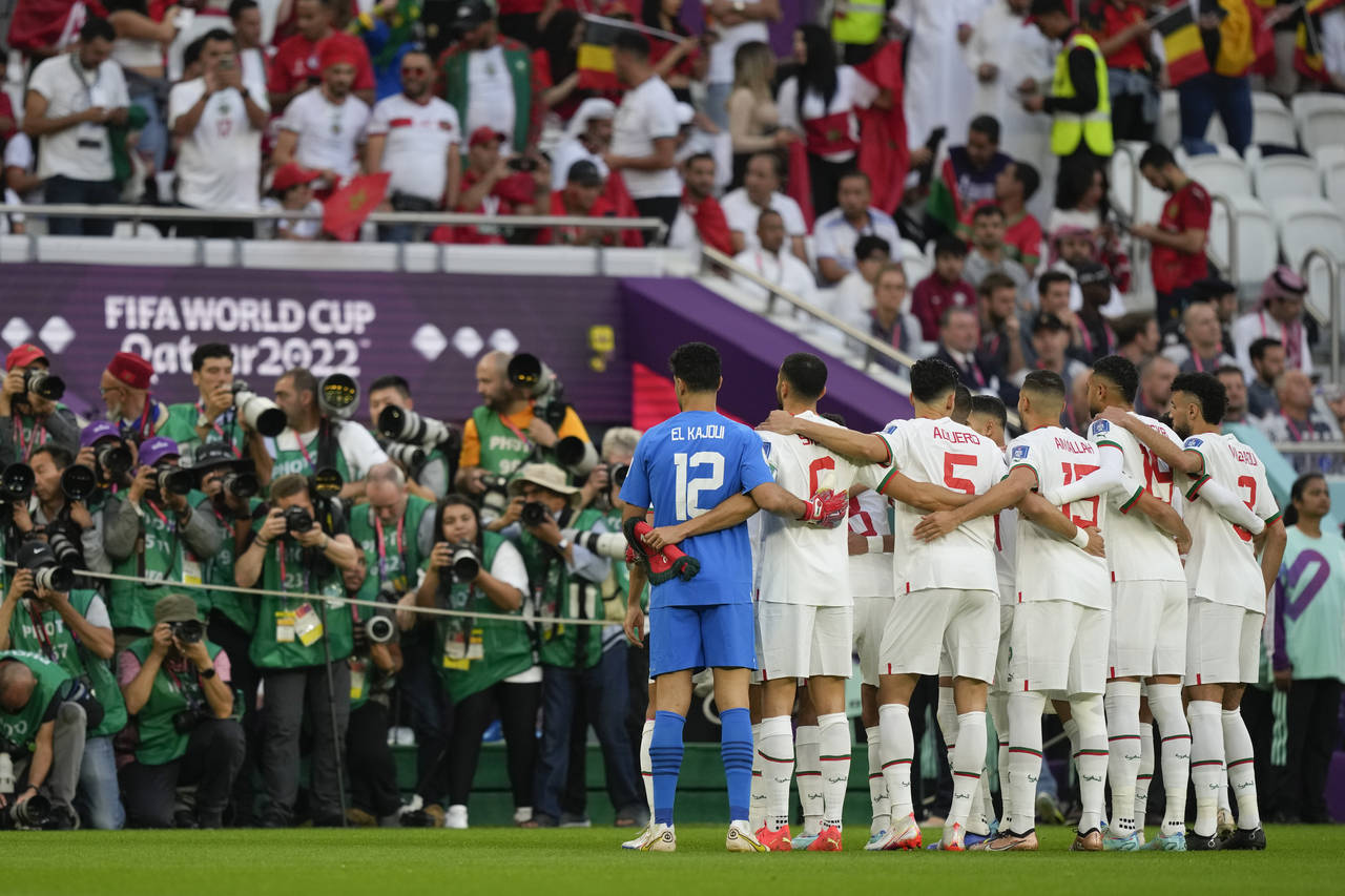 Morocco players pose for photographers prior to the World Cup group F soccer match between Belgium ...