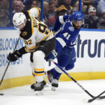 
              Boston Bruins left wing Tomas Nosek (92) controls the puck in front of Tampa Bay Lightning left wing Pierre-Edouard Bellemare (41) during the first period of an NHL hockey game Monday, Nov. 21, 2022, in Tampa, Fla. (AP Photo/Chris O'Meara)
            