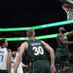 
              Boston Celtics guard Jaylen Brown drives to the basket ahead of Dallas Mavericks defenders during the first half of an NBA basketball game, Wednesday, Nov. 23, 2022, in Boston. (AP Photo/Mary Schwalm)
            