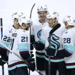 
              Seattle Kraken center Alex Wennberg (21) celebrates with teammates after scoring a goal during the third period of the team's NHL hockey game against the Minnesota Wild, Thursday, Nov. 3, 2022, in St. Paul, Minn. (AP Photo/Abbie Parr)
            
