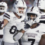 
              Mississippi State running back Jo'quavious Marks (7) gestures after scoring on a 1-yard touchdown run against Mississippi during the first half of an NCAA college football game in Oxford, Miss., Thursday, Nov. 24, 2022. (AP Photo/Rogelio V. Solis)
            