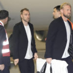 
              Kasper Schmeichel of the Denmark's national soccer team, right, arrives with teammate Christian Eriksen at Hamad International airport in Doha, Qatar, Tuesday, Nov. 15, 2022 ahead of the upcoming World Cup. Denmark will play their first match in the World Cup against Tunisia on Nov. 22. (AP Photo/Hassan Ammar)
            