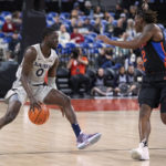 
              Xavier guard Souley Boum, left, is defended by Florida guard Trey Bonham during the first half of an NCAA college basketball game in the Phil Knight Legacy tournament in Portland, Ore., Thursday, Nov. 24, 2022. (AP Photo/Craig Mitchelldyer)
            