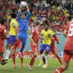 
              Switzerland's goalkeeper Yann Sommer, top, catches the ball during the World Cup group G soccer match between Brazil and Switzerland at the Stadium 974 in Doha, Qatar, Monday, Nov. 28, 2022. (AP Photo/Hassan Ammar)
            