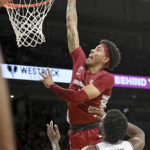 
              Arkansas forward Jalen Graham, top, dunks over Fordham forward Romad Dean, bottom, during the second half of an NCAA college basketball game Friday, Nov. 11, 2022, in Fayetteville, Ark. (AP Photo/Michael Woods)
            
