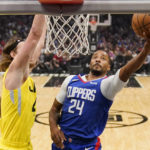 
              Los Angeles Clippers forward Norman Powell, right, shoots as Utah Jazz forward Kelly Olynyk defends during the first half of an NBA basketball game Monday, Nov. 21, 2022, in Los Angeles. (AP Photo/Mark J. Terrill)
            