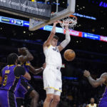 
              Utah Jazz center Walker Kessler dunks against the Los Angeles Lakers during the first half of an NBA basketball game Friday, Nov. 4, 2022, in Los Angeles. (AP Photo/Marcio Jose Sanchez)
            