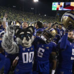 
              Washington players and their mascot celebrate after defeating Oregon in an NCAA college football game Saturday, Nov. 12, 2022, in Eugene, Ore. . (AP Photo/Andy Nelson)
            