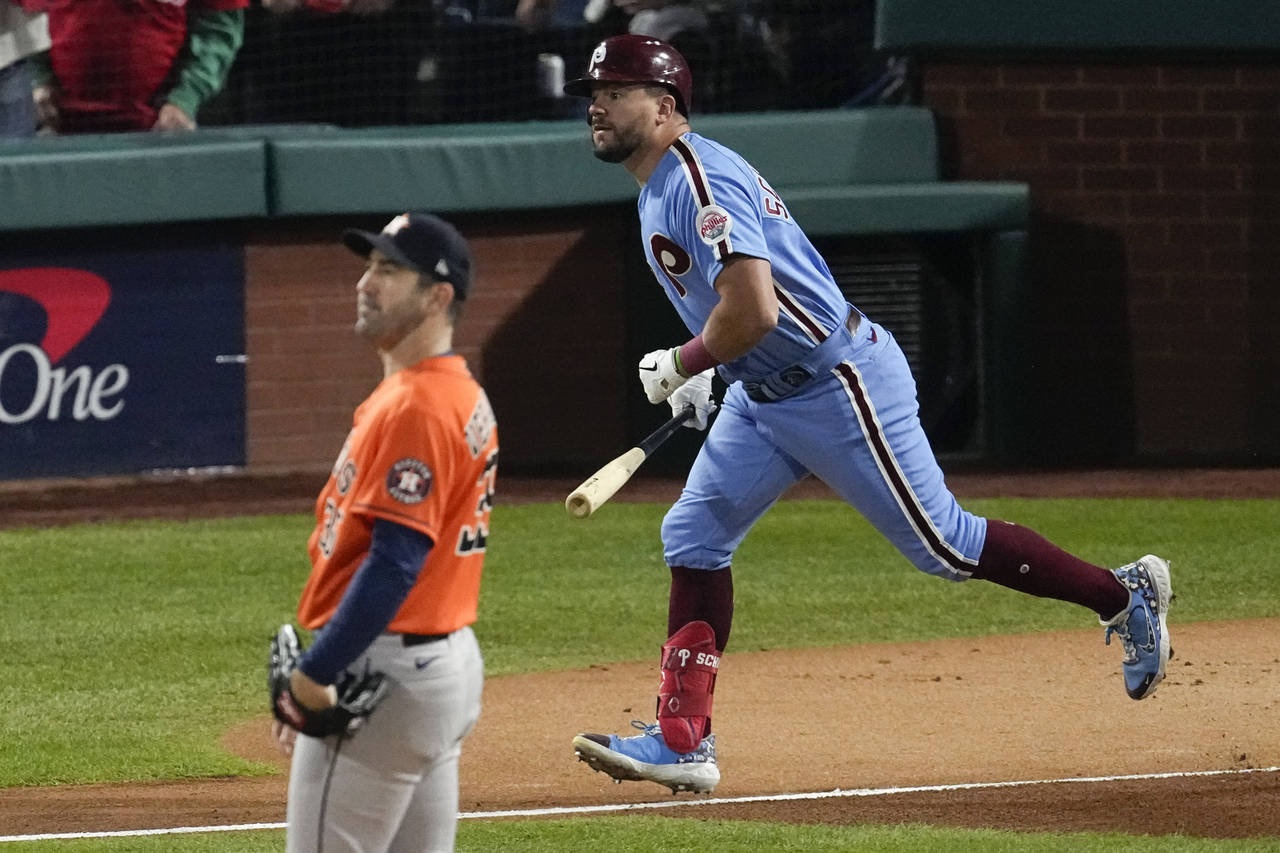 Philadelphia Phillies' Kyle Schwarber watches his home run off Houston Astros starting pitcher Just...