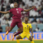 
              Qatar's Pedro Miguel, left, challenges for the ball with Ecuador's Pervis Estupinan during the World Cup group A soccer match between Qatar and Ecuador at the Al Bayt Stadium in Al Khor, Qatar, Sunday, Nov. 20, 2022. (AP Photo/Darko Bandic)
            