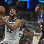 
              Minnesota Timberwolves center Karl-Anthony Towns (32) shoots in front of Indiana Pacers center Myles Turner (33) during the first half of an NBA basketball game in Indianapolis, Wednesday, Nov. 23, 2022. (AP Photo/AJ Mast)
            