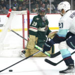 
              Seattle Kraken center Alex Wennberg (21) skates with the puck as Minnesota Wild goaltender Marc-Andre Fleury (29) watches during the first period of an NHL hockey game Thursday, Nov. 3, 2022, in St. Paul, Minn. (AP Photo/Abbie Parr)
            