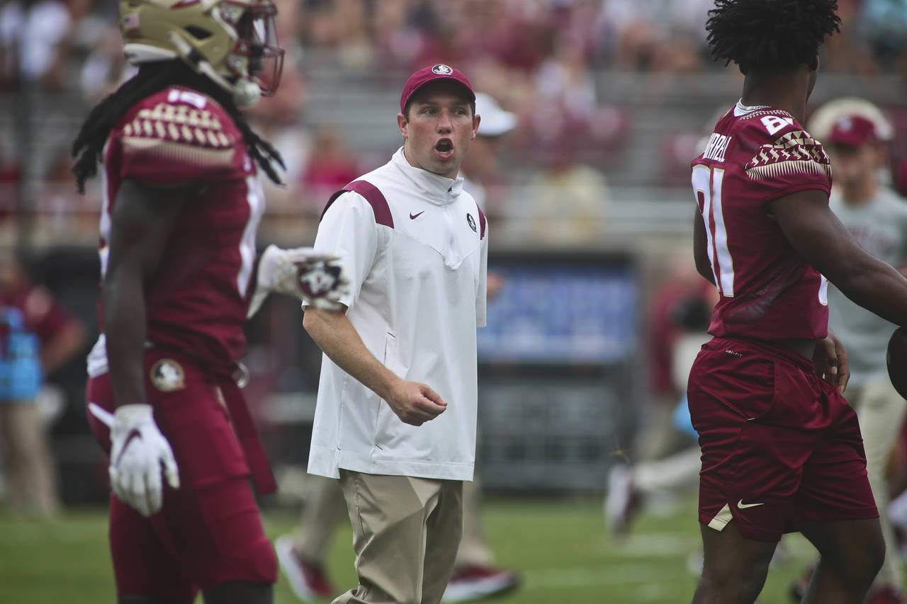 FILE - Then-Florida State offensive coordinator/quarterbacks coach Kenny Dillingham talks to player...