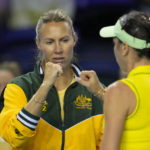 
              Australia team captain Alicia Molik bumps fists with Australia's Ajla Tomljanovic, right, during her final match of the Billie Jean King Cup tennis finals against Switzerland's Belinda Bencic, at the Emirates Arena in Glasgow, Scotland, Sunday, Nov. 13, 2022. (AP Photo/Kin Cheung)
            